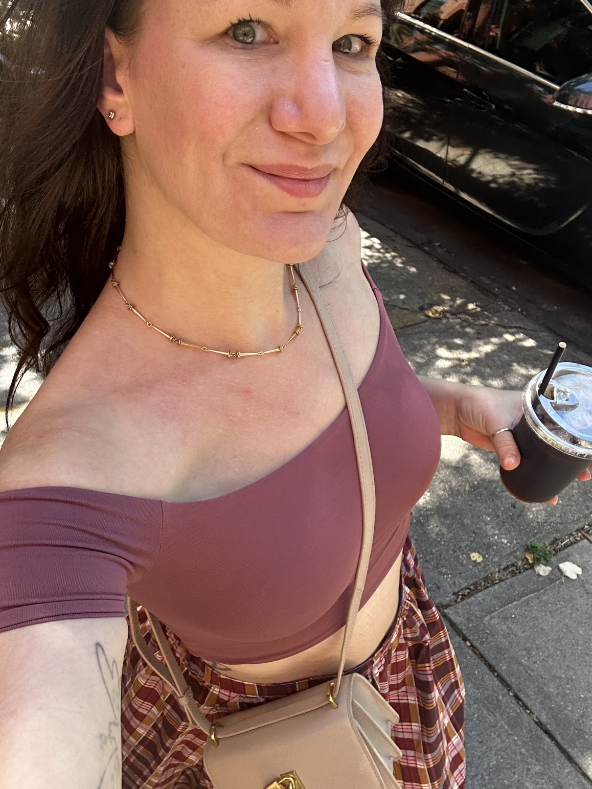 Liesa on a Brooklyn sidewalk with an iced coffee